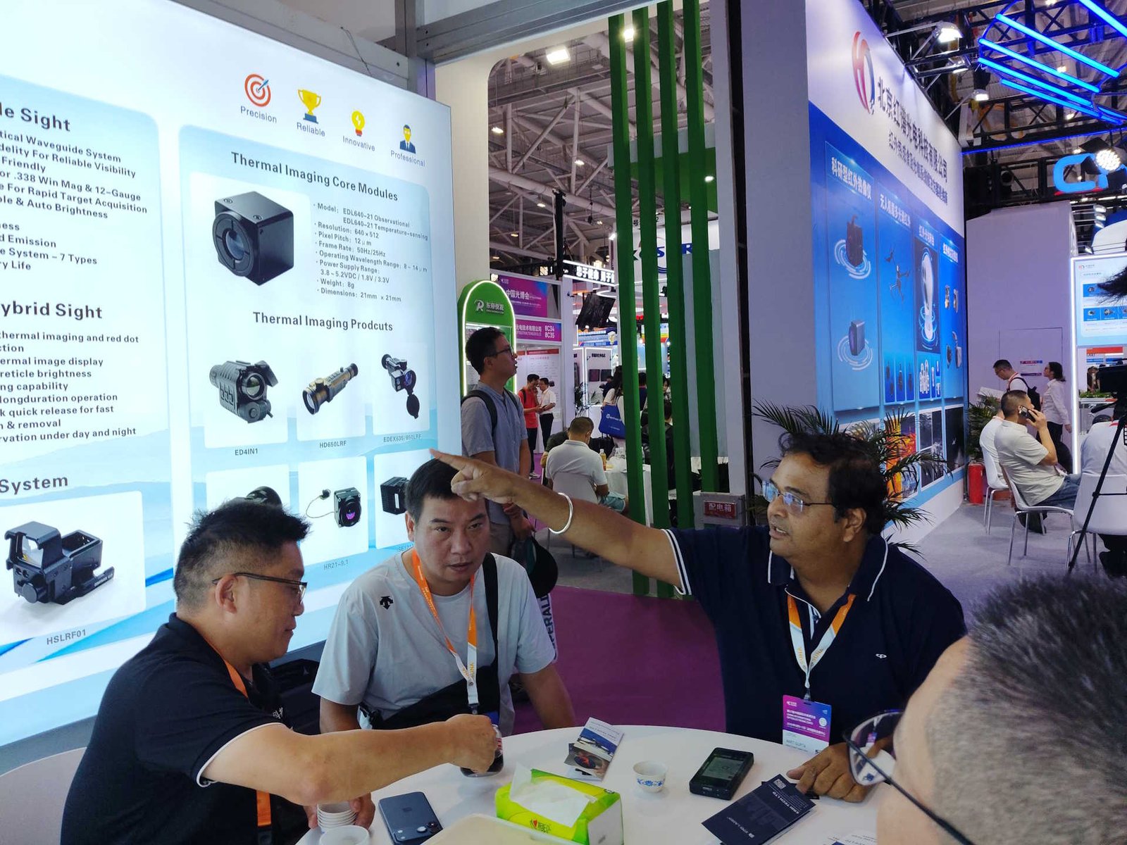 ERDI engineers discussing thermal imaging module integration with visitors